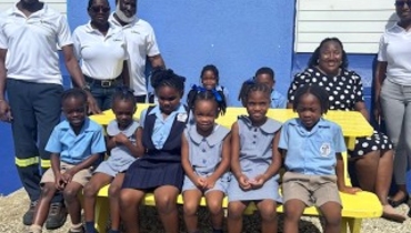 Students of the St. Bartholomew Primary School, enjoying the donated Bench. | Barbados National Energy Company Ltd.